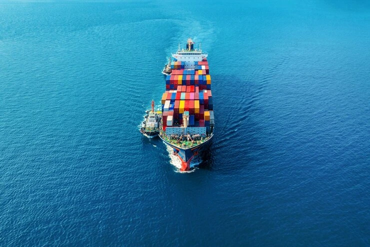 cargo ship with containers sailing in open sea