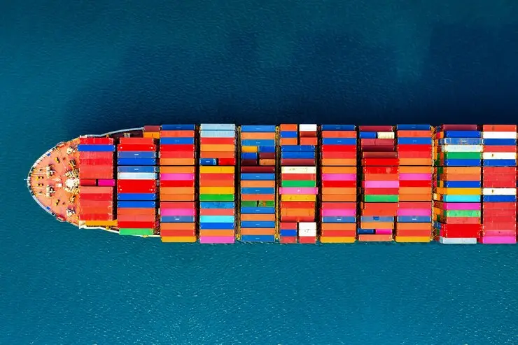 top down view of a cargo ship traveling across the ocean